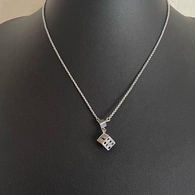 A Christian Dior Vintage Silver Tone Dice Pendant Necklace